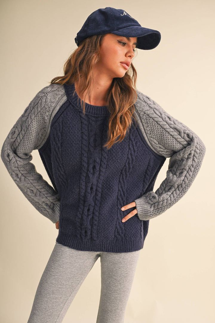 COLOR BLOCK CABLE KNIT SWEATER