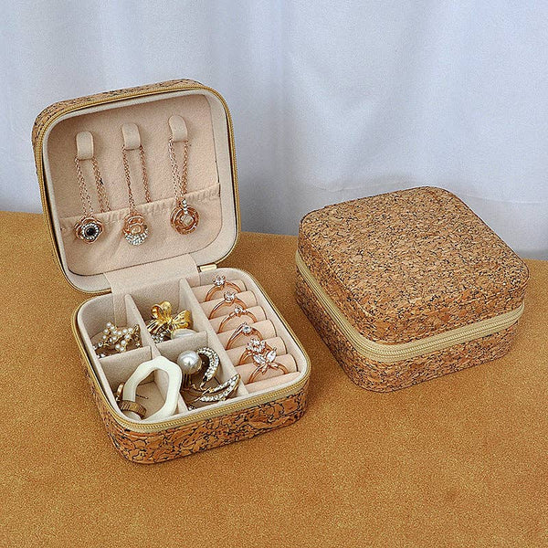 Jewelry box with cork exterior and interior, containing necklaces and rings.