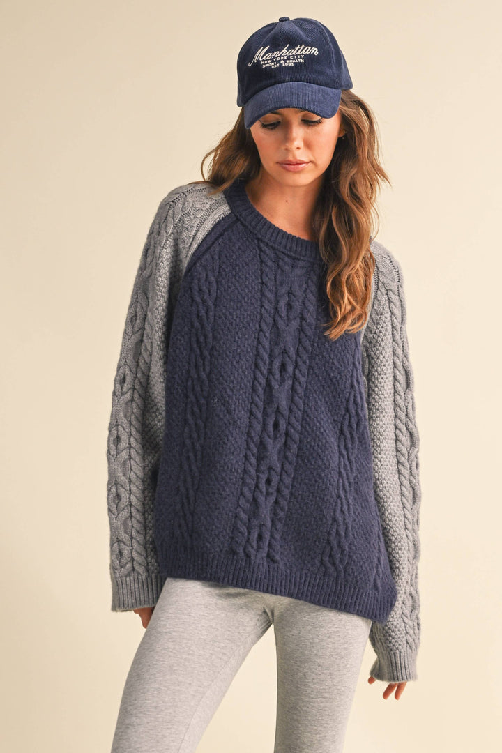 COLOR BLOCK CABLE KNIT SWEATER