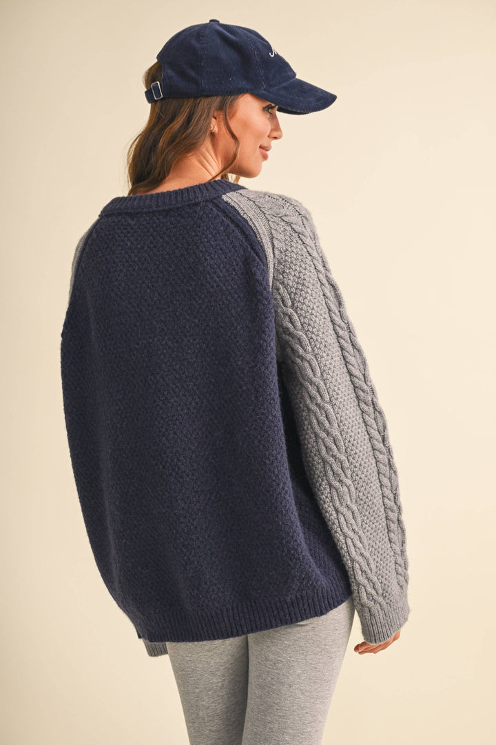 COLOR BLOCK CABLE KNIT SWEATER