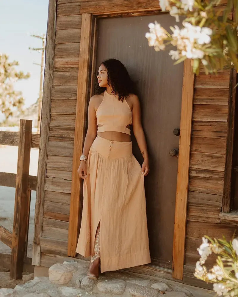 Tan linen top and maxi skirt styled by a desert cabin door