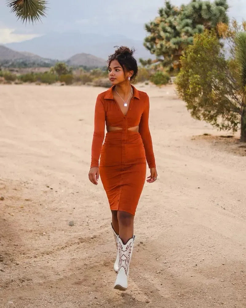 Model in a rust knit cutout set and white western boots