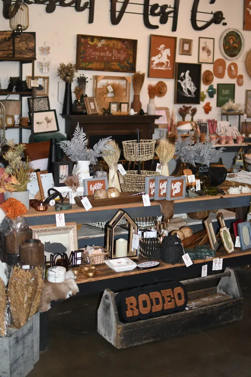 Gift and home decor display under the Desert Nest Co. wall sign